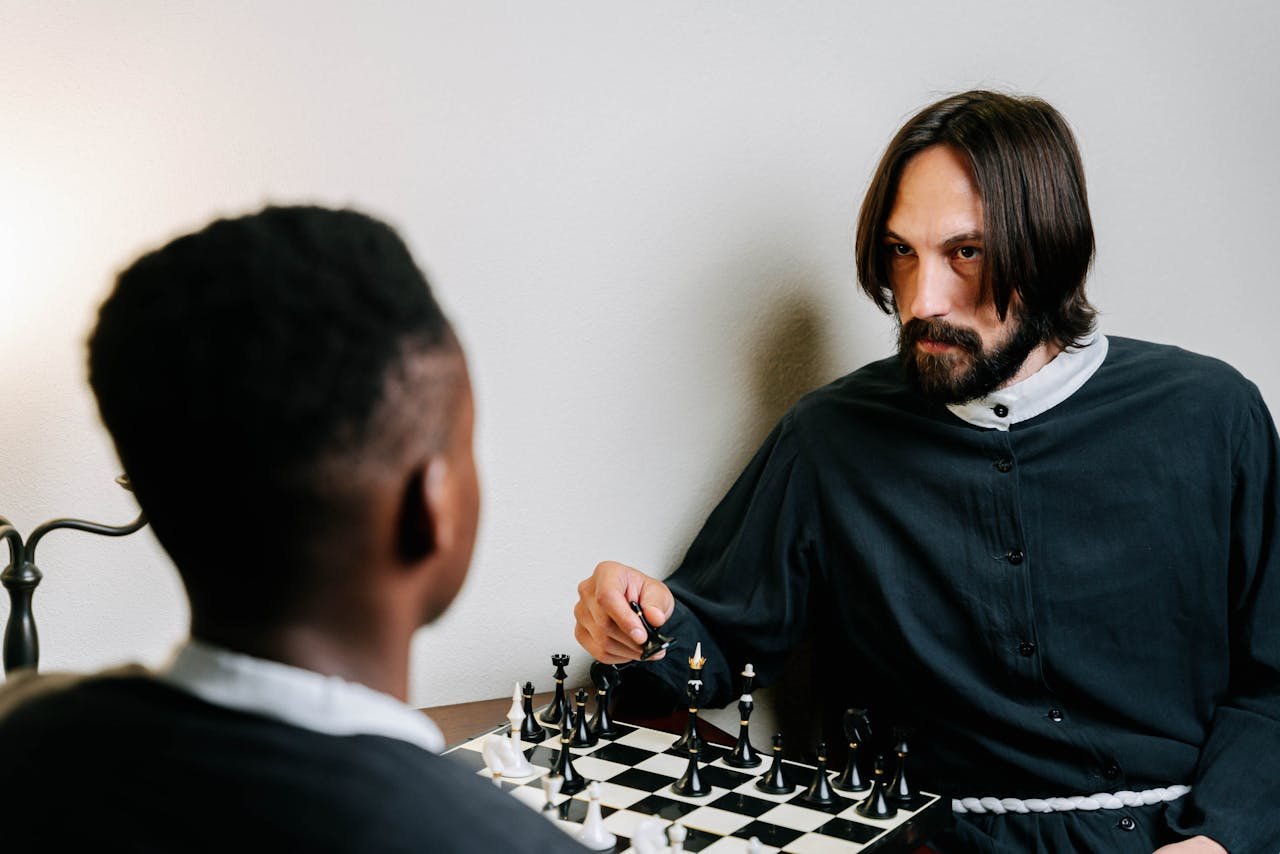 services-02 Two men engaged in a strategic chess game, focused and thoughtful.